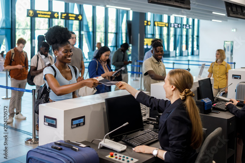 Travelers check in at an airport during a busy morning