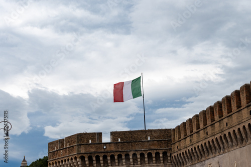 Fotografie Italian tricolour flag green white red windblown on flagstaff in Rome and cloudy