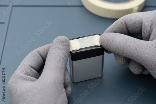 Battery Recycling Collection Gloved Hands Smoothing Nonconductive Tape
