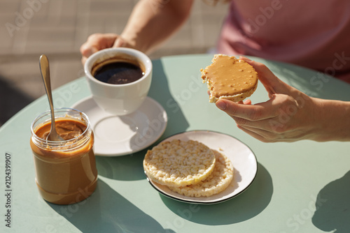 Peanut Butter Spread On Rice Cake With Coffee For Snack