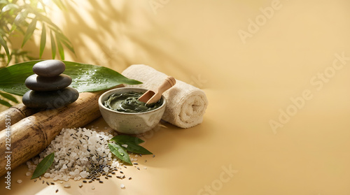 a bamboo stick with a bowl of green tea and a bowl of white rice on it