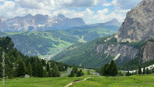 Scenic dolomite mountains landscape with green valley