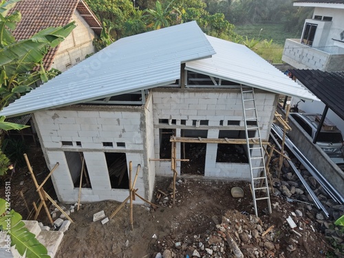 Construction Site of House with Metal Roof and Concrete Blocks