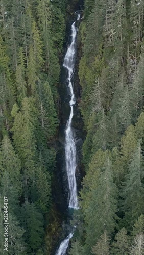 Majestic Waterfall Cascading Through Ancient Evergreen Forest in British Columbia, Canada