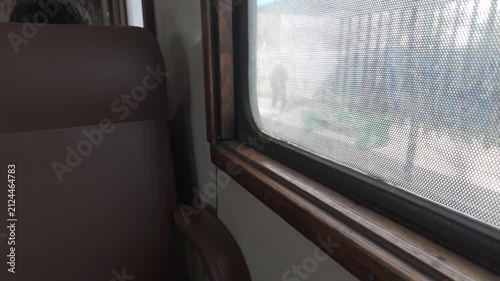 Wooden window frame and empty seat inside the University Train railcar in La Plata, Buenos Aires, Argentina. D-Log M, 10-bit color, flat log profile.