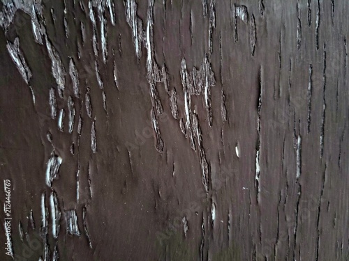 Abstract wood textured background with vertical streaks of light and dark colors.