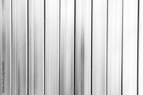 Abstract elegant with shadow light on vertical lines pattern on shiny silver with smooth on aluminum surface textures background.