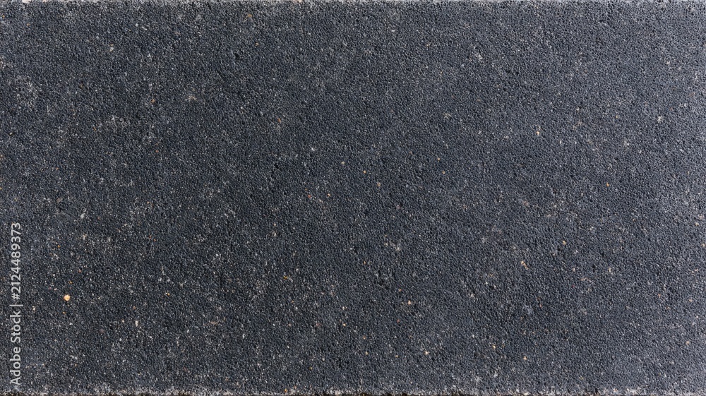 Fototapeta premium Dark grey concrete paver texture high definition architectural paving stone surface detail.