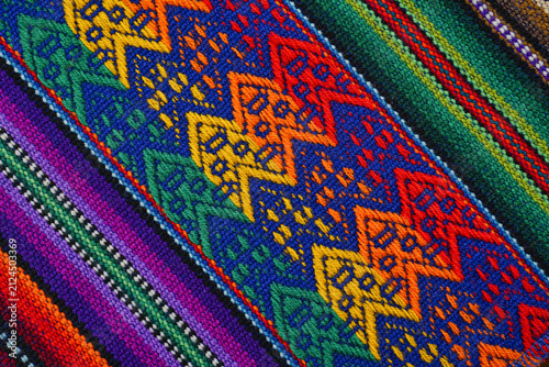 Colorful Peruvian woven striped textile with geometric strips and traditional pattern