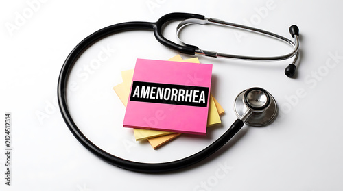 Stethoscope with pink sticky note labeled amenorrhea