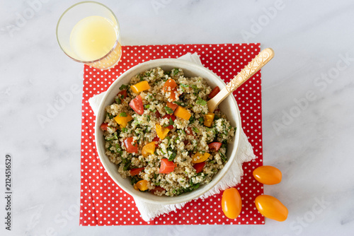Close-up of a bowl of homemade tabbouleh made with quinoa, tomatoes, mint, and parsley.