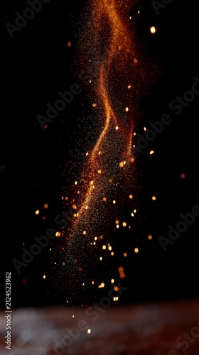 Floating golden particles and magical glowing sparks on black background