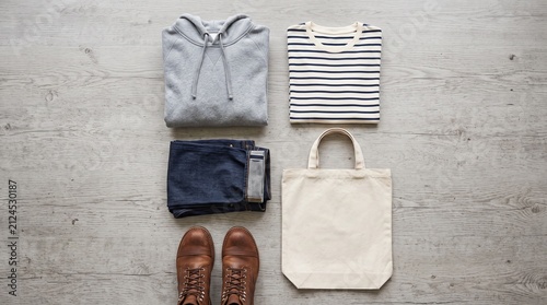 Mens casual clothing outfit flat lay with hoodie jeans boots and blank tote bag