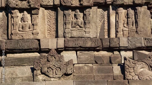 Weathered narrative relief carvings line the ancient stone walls of Prambanan Temple, preserving detailed Hindu artistry.