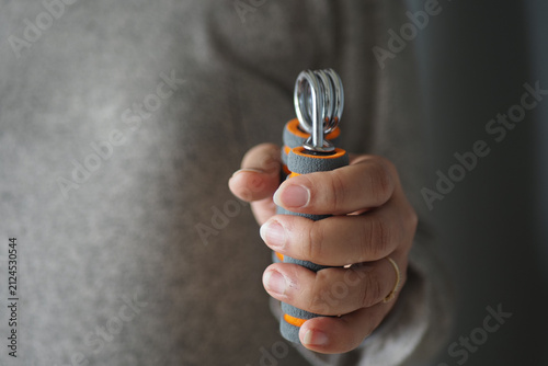 Принти на полотні Hand holding exercise grip tool for strength training