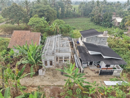 Aerial View of Rural Home Construction Amidst Lush Greenery