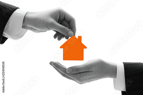 Business hands holding small orange house