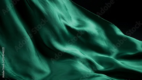 Emerald silk fabric waves flowing gracefully in motion capture digital video for elegant luxury background design