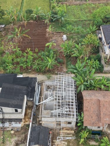 Aerial View of Rural Construction Site with Banana Plantations and Farmland