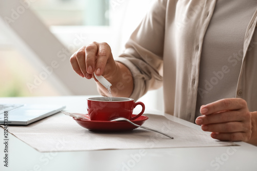 Woman adding artificial swe...