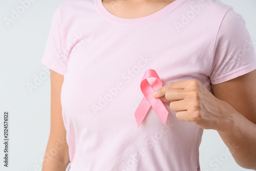 Young woman with pink ribbo...