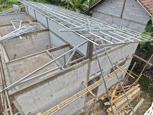 Construction Site with Metal Roof Trusses on Brick Building