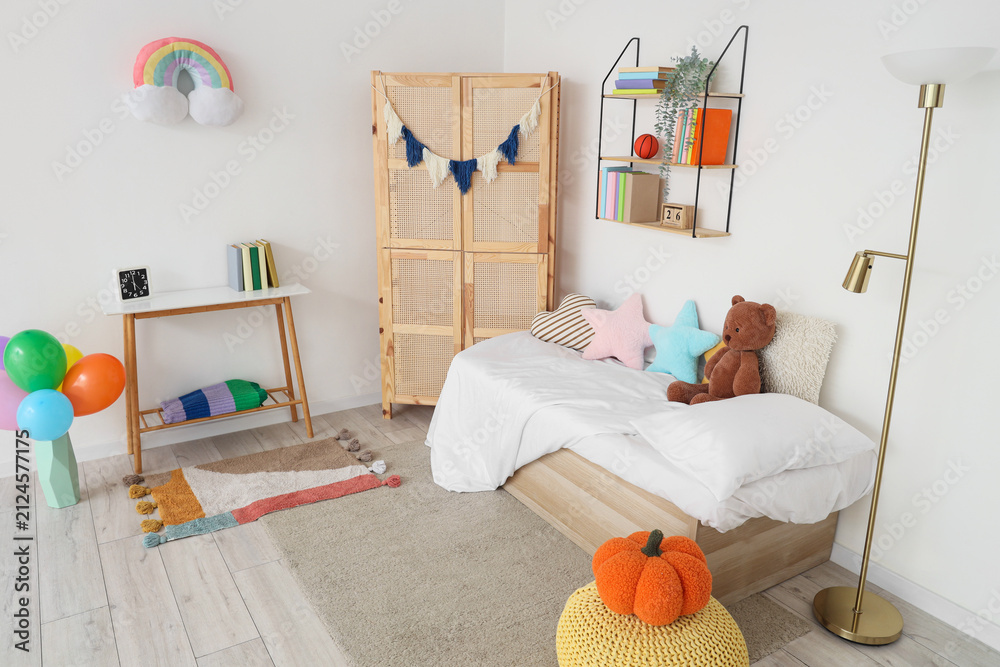 Fototapeta premium Interior of childrens room with bed, closet and bookshelf