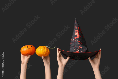 Female hand with pumpkins a...