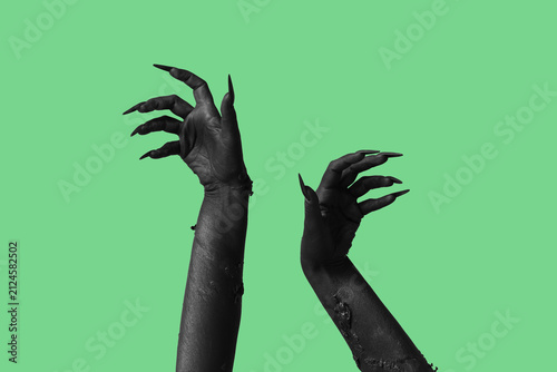 Black hands of witch on gre...