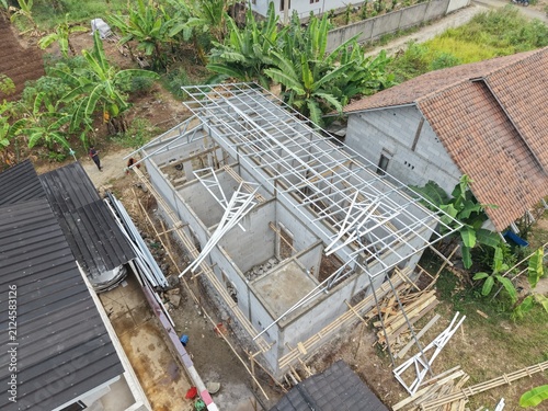 Aerial View of Building Construction with Metal Roof Frame and Banana Plantation