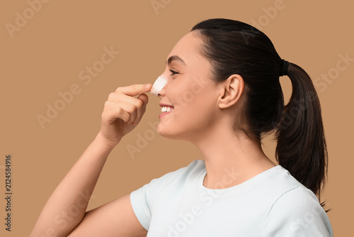 Young woman pointing at ban...