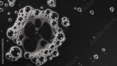 Abstract White Foam Bubbles Expanding on Black Background