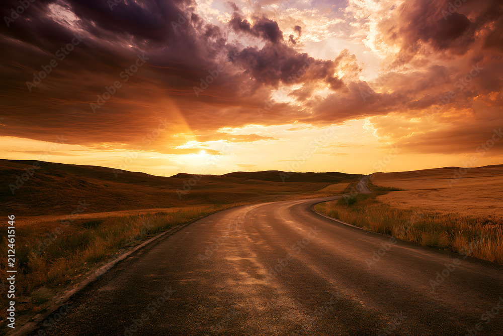 Obraz premium An empty road paved with asphalt set against a rural countryside backdrop during sunset, framed by dramatic clouds