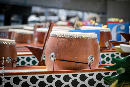 Traditional wooden drums are mounted inside dragon boats awaiting the start of a race 