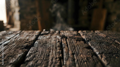 Empty Dark Rustic Wooden Table Surface in Dimly Lit Room for Product Mockup