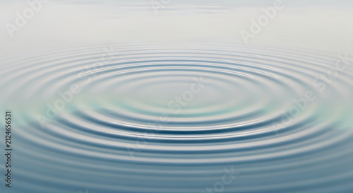 Ripples spreading gently across a calm water surface