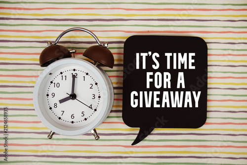 It's Time For A Giveaway text on speech bubble with alarm clock on colorful stripes background