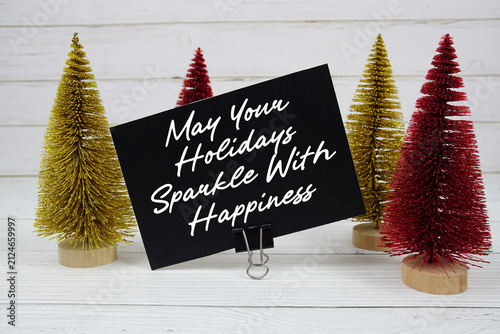 May Your Holidays Sparkle with Happiness text written on paper card for Christmas holidays celebration