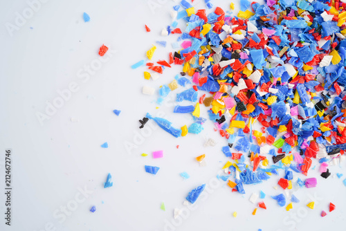 Fotografie Plastic colorful pieces recycling shredded for industrial use.