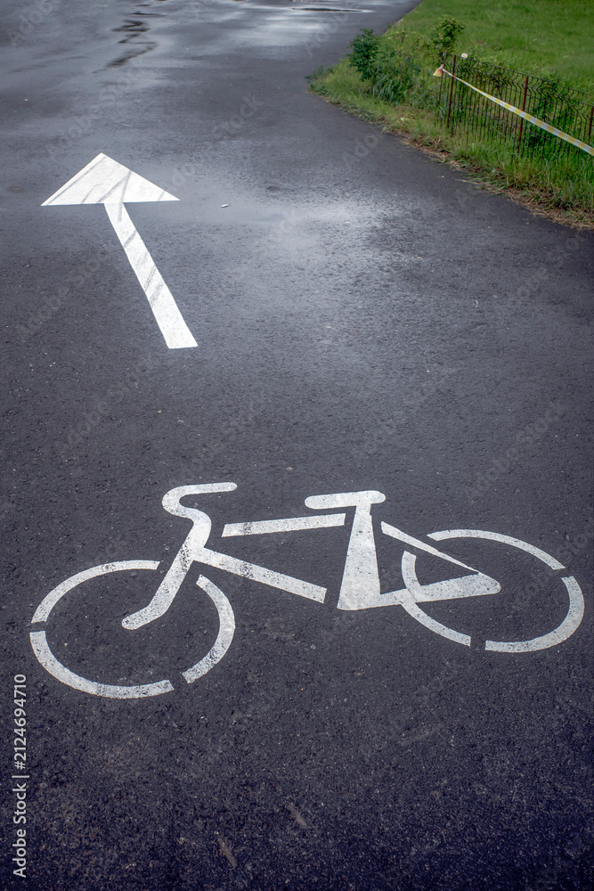Fototapeta premium Marking on a bike path in a city park on a summer day