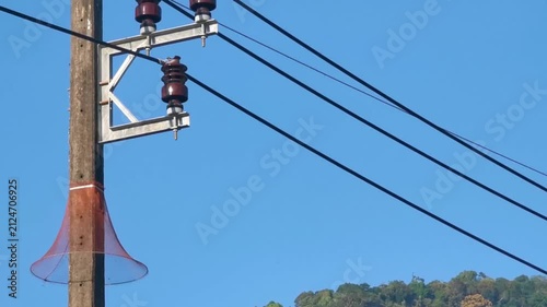 Thai power pole with cables generator under clear blue sky Thailand.