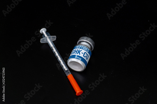 GHK-Cu Peptide Vial with Insulin Syringe on Black Background
