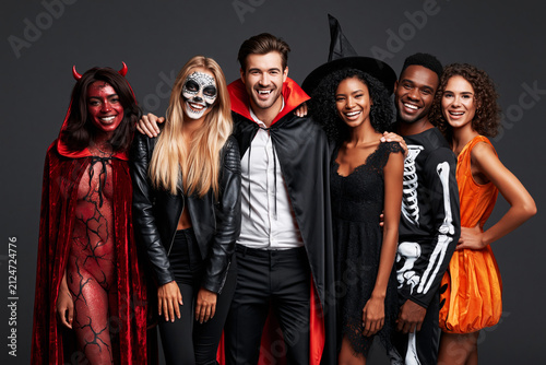 Group of friends in devil, skeleton, vampire and witch Halloween costumes, group party concept
