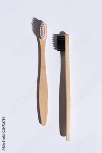 Fotografía two bamboo toothbrushes isolated on white background, front and side views with