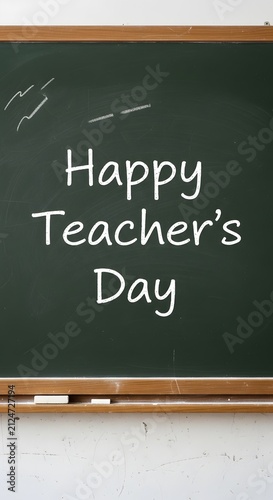 Happy teachers day handwritten text on green school chalkboard with chalkboard, education