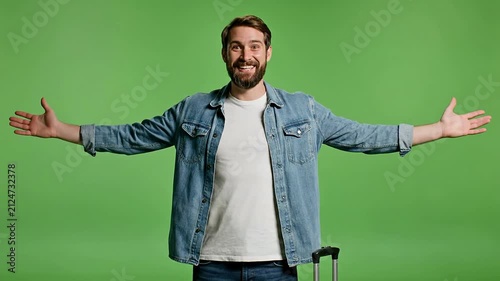 Joyful Man with Open Arms and Suitcase on Green Screen Signifying Exciting Airport Arrival and Travel Reunion