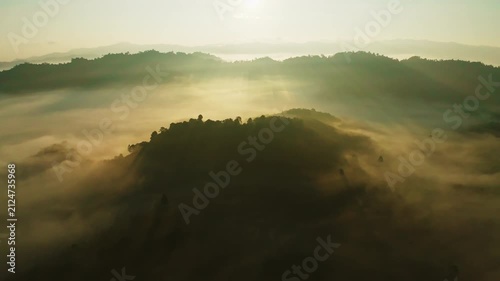 Amazing sunrise with fog move flowing over mountains,Sunrise sky,Aerial view Drone flies over clouds,Rainforest Clouds and fog in sunrise light, Nature and travel background
