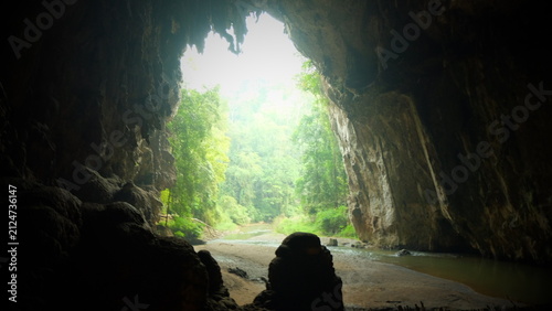 Bild auf Leinwand Bamboo raft passing along natural lake in limestone cave