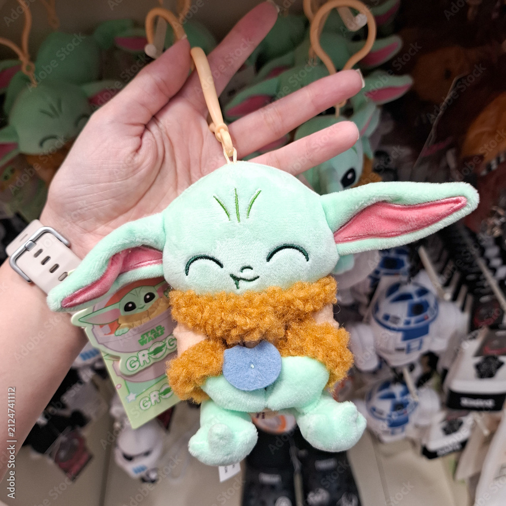 Fototapeta premium Cute Plush Alien Keychain Character Hanging Accessory Held In Hand Close Up View on June 7, 2026 in Bangkok, Thailand