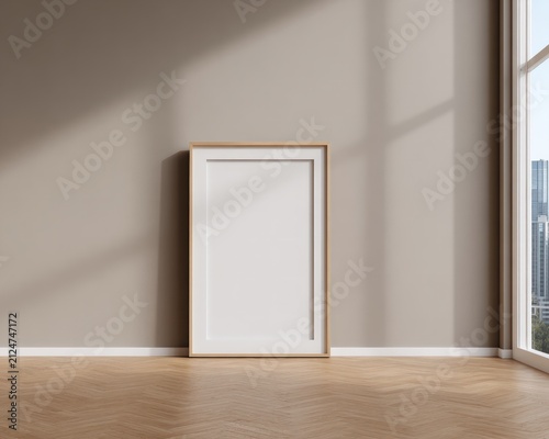 Empty wooden picture frame leaning against beige wall on herringbone floor with copy space for minimalist interior design home staging